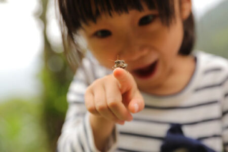Young girl with insect on finger